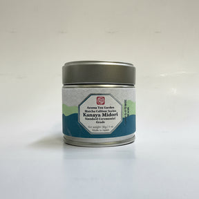 A tin container of Azuma Tea Garden's Kanaya Midori matcha, placed on a surface with natural lighting.