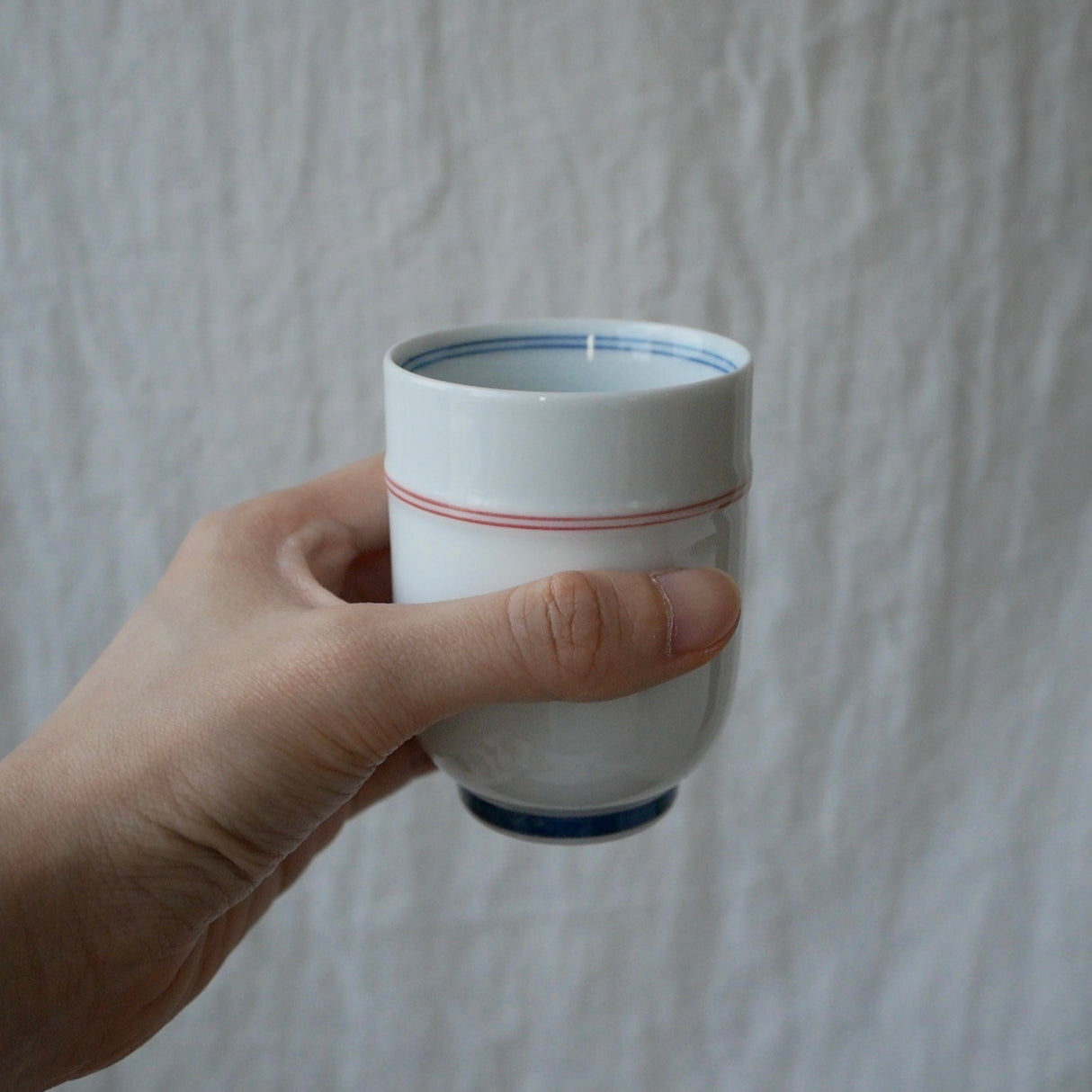 Saikai Ceramics: Red Trim, White Porcelain Yunomi Tea Cup with Blue Accents 150 ml - Yunomi.life